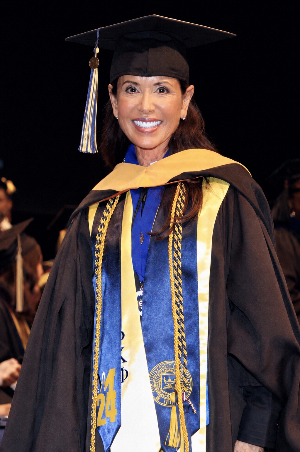 Lisa Neilson in cap and gown at the 2024 University of Michigan School of Social Work commencement